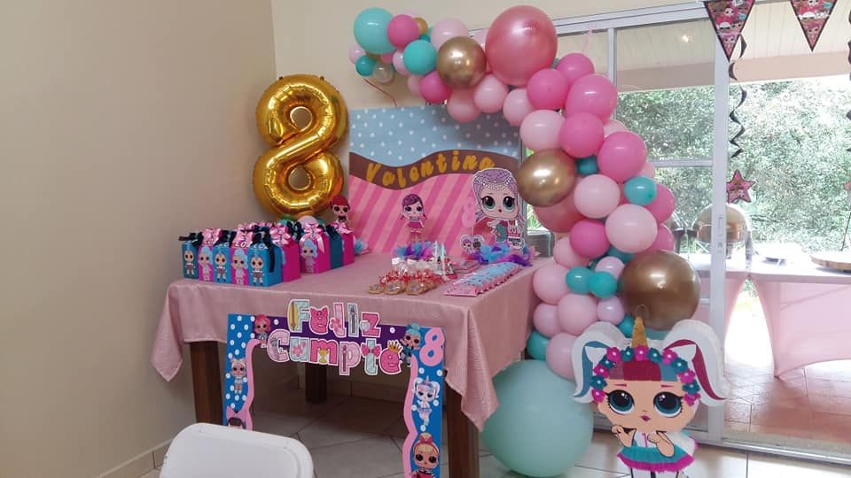 Birthday party table with a balloon arch