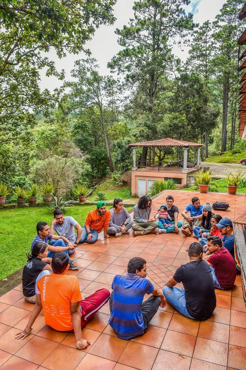 Young people sitting in a circle on the porch