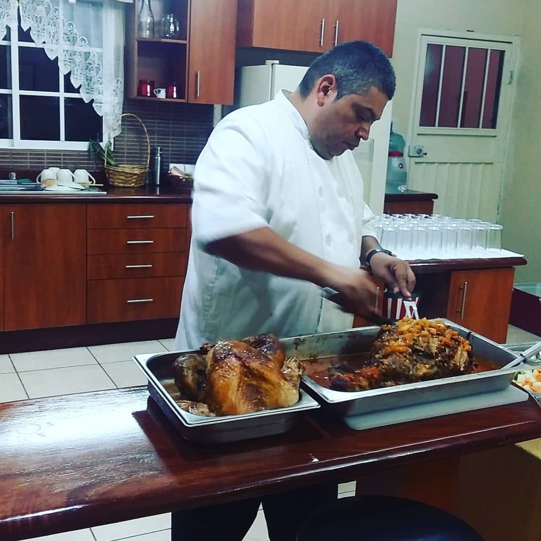 Chef carving roast meats for a banquet