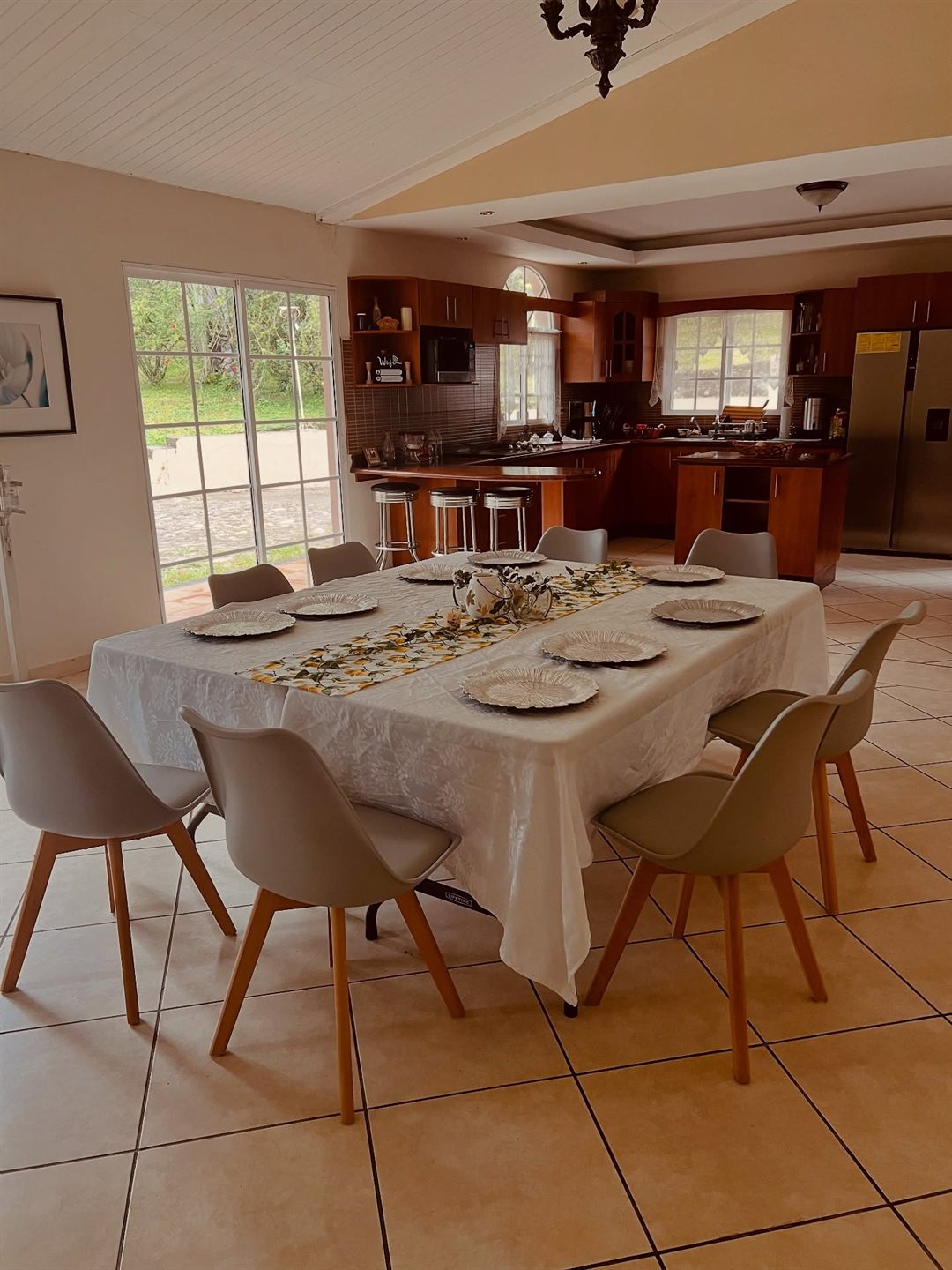 Dining table set for eight next to the open kitchen