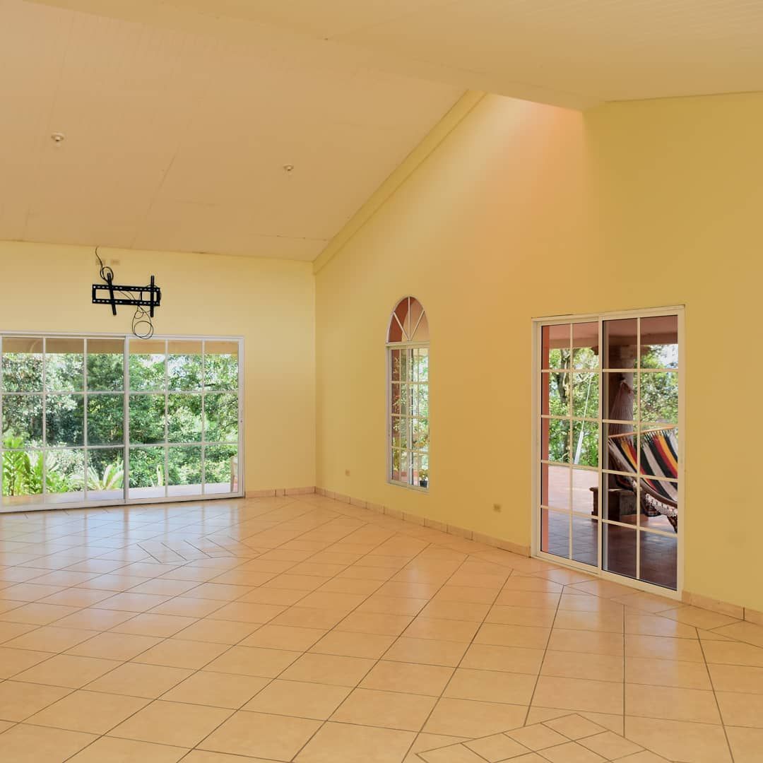 Bright empty event hall with arched windows