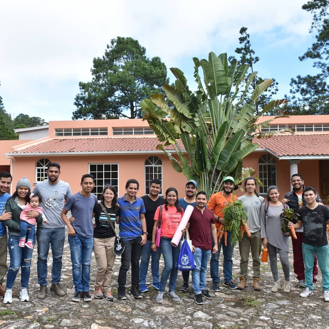 A visiting group in front of the villa