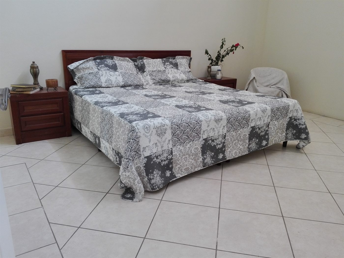 King room with a large bed, nightstands and framed pictures