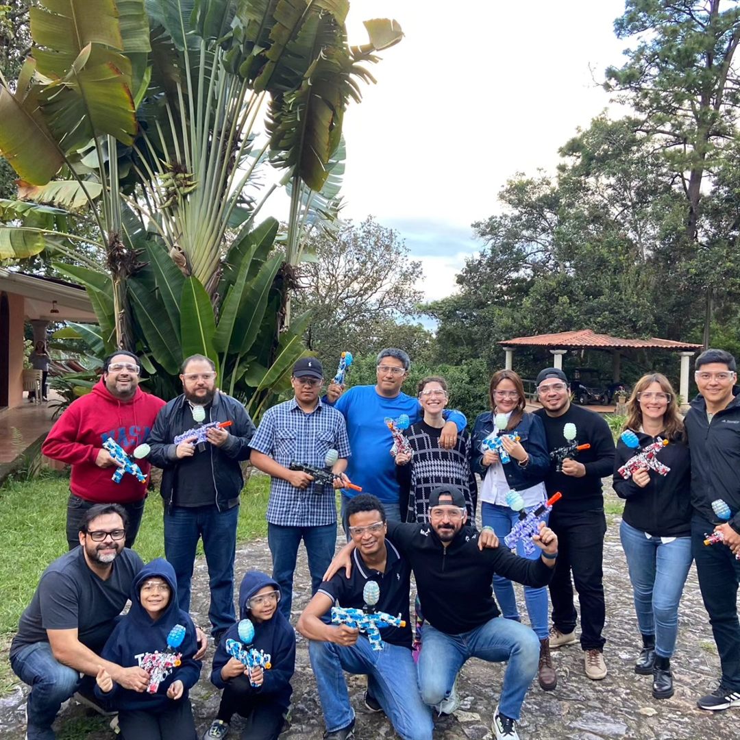 Group of friends with gel blasters after a match outdoors
