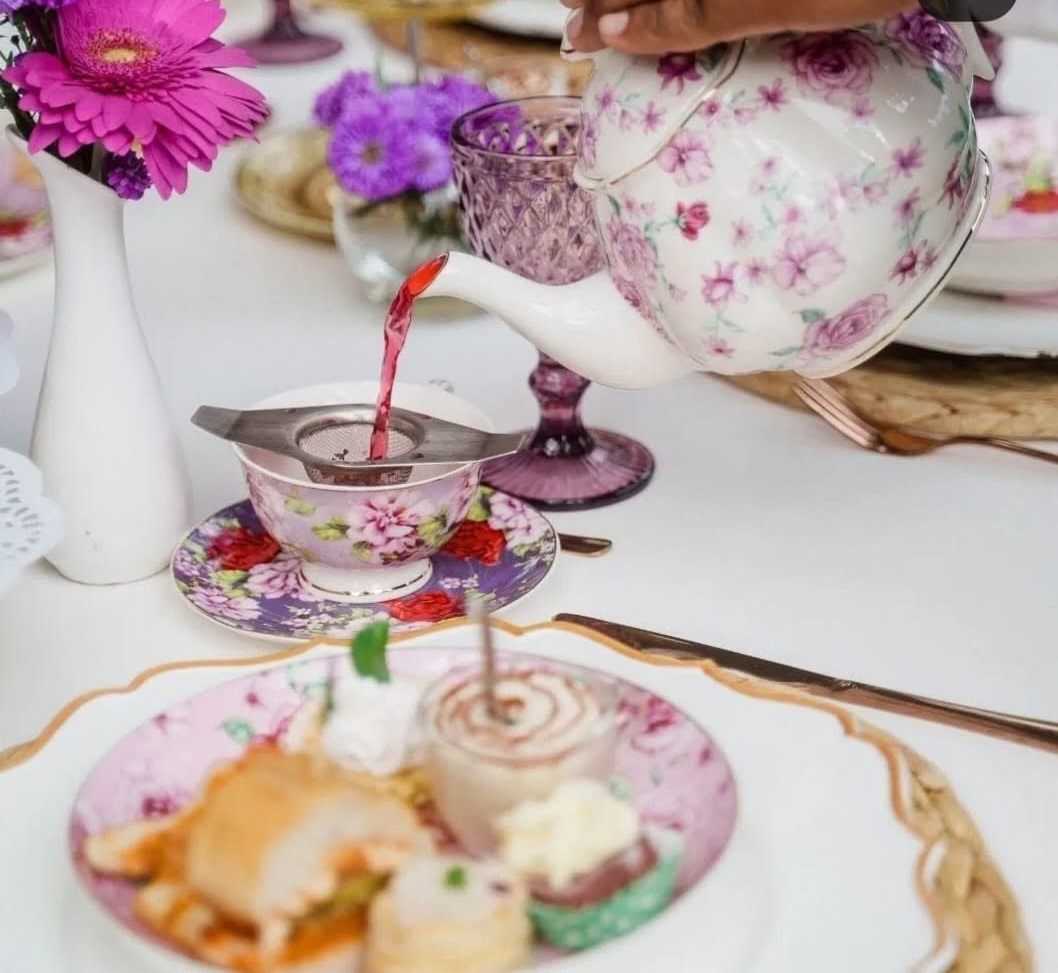 Tea set with pastries and flowers
