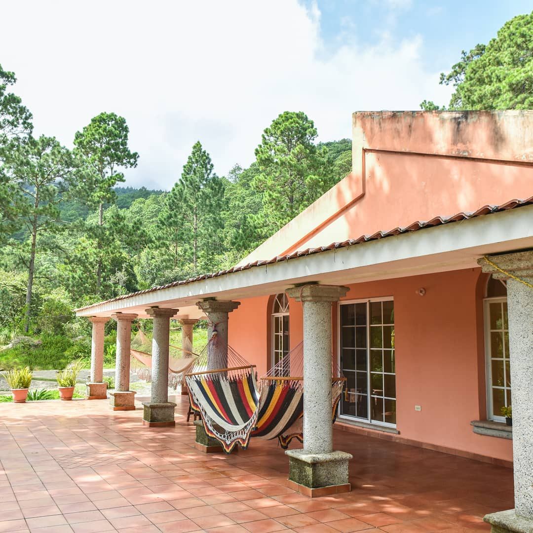 Side of the villa with a hammock on the porch