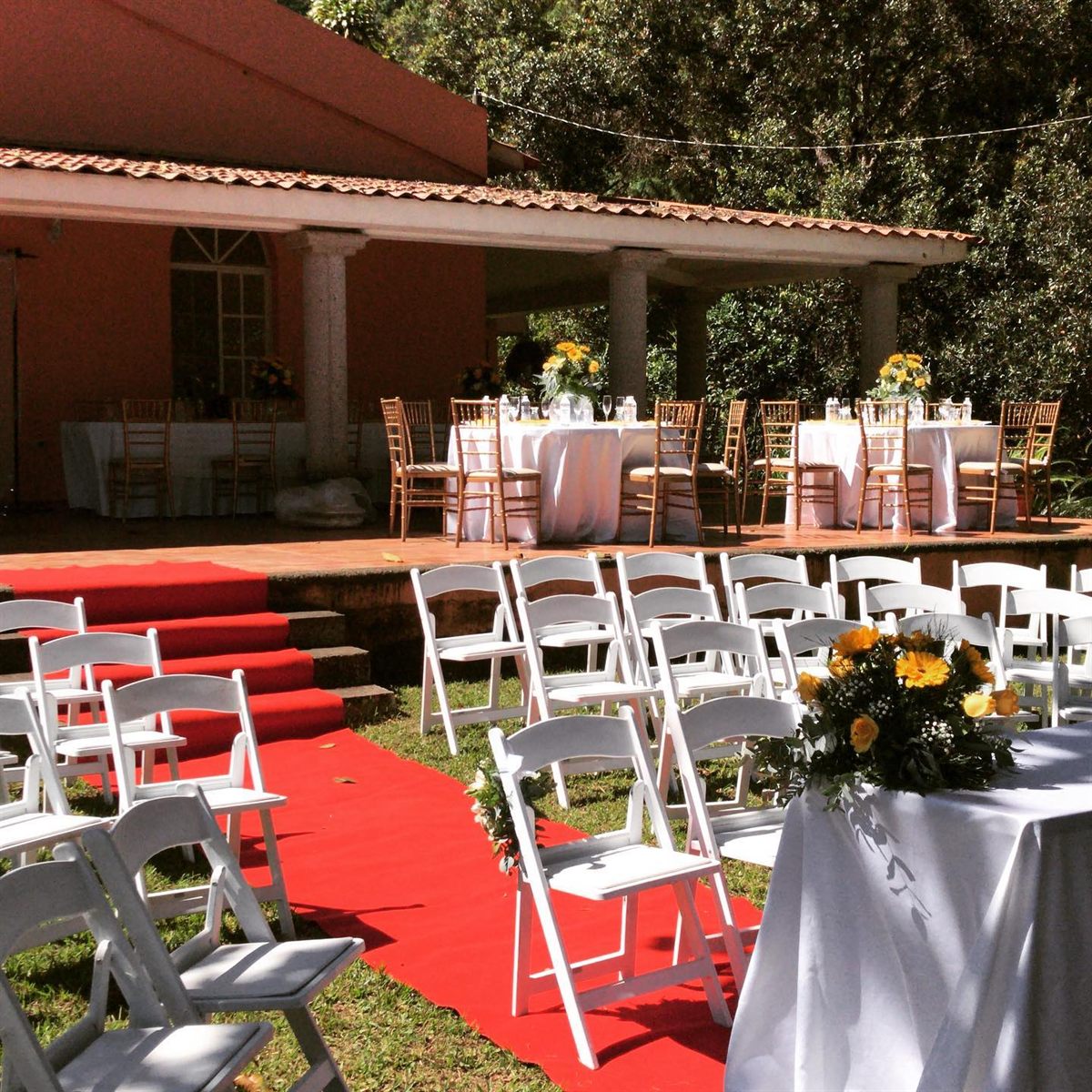 Wedding ceremony set up on the lawn in front of the villa