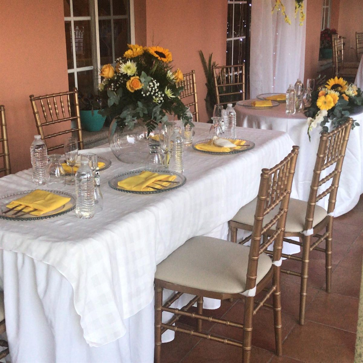 Wedding table with yellow flowers on the porch